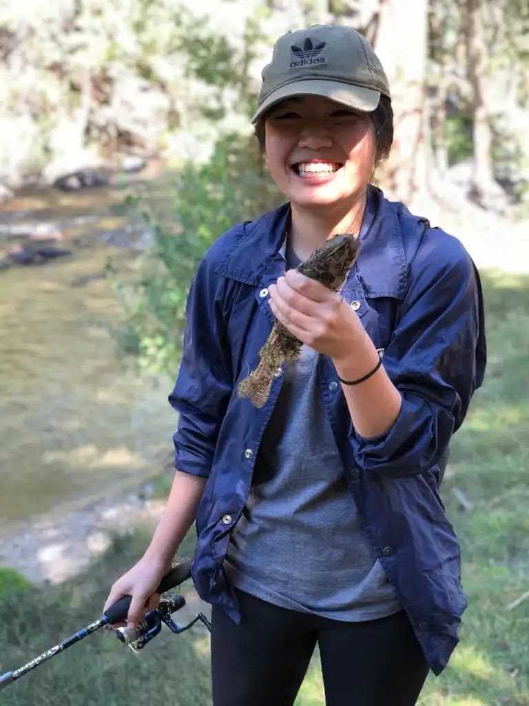 A happy fisherman with a stocker rainbow pulled out from Rock Creek